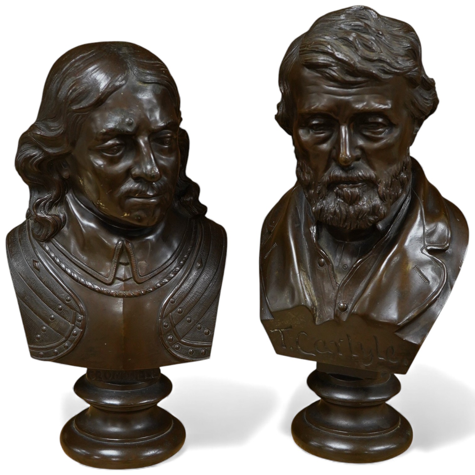 Two bronze busts of Oliver Cromwell, indistinctly signed and Thomas Carlyle, largest 26cm high